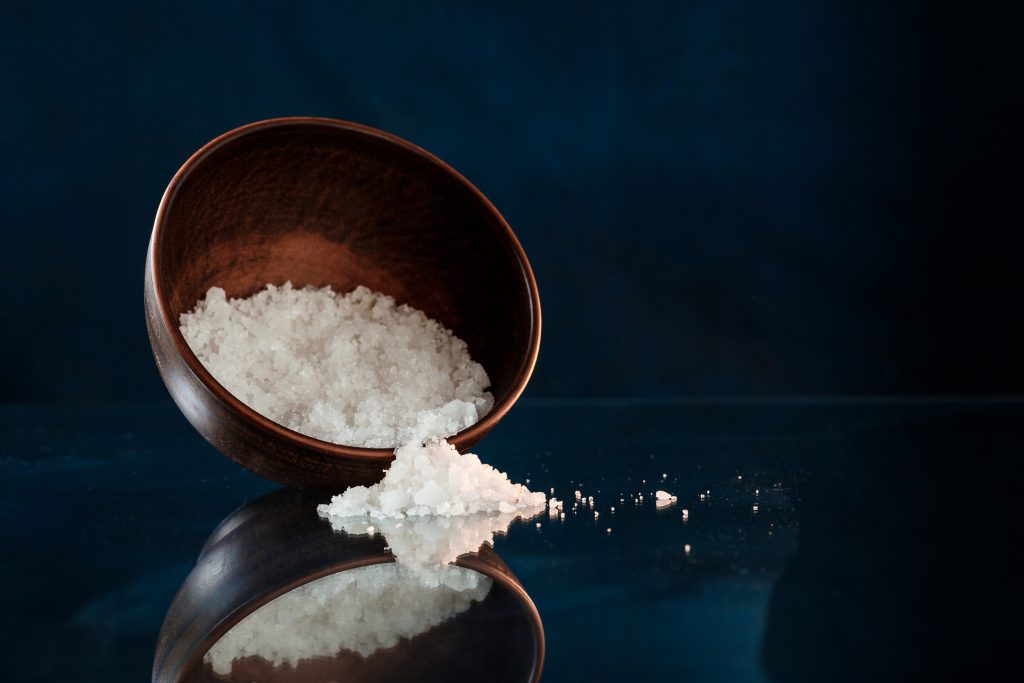 sea salt wooden bowl black background